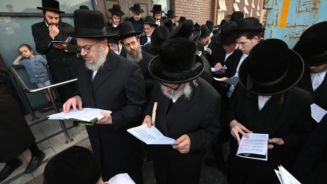 The firebombed Adass Israel Synagogue in Ripponlea, Melbourne, holds a ceremony at tonight where Rabbi Kohn blesses some of the items that were burned in the fire the other week. They have cleared out all the holy books and placed them in a skip. This blessing was held alongside community members only for men. Picture: Tony Gough