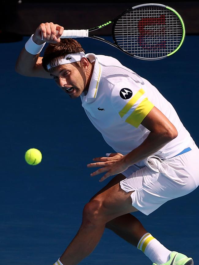 Serbia's Filip Krajinovic hits a return against Medvedev. Picture: AFP