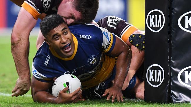 Two Broncos couldn’t Michael Jennings scoring. Photo: Bradley Kanaris/Getty Images