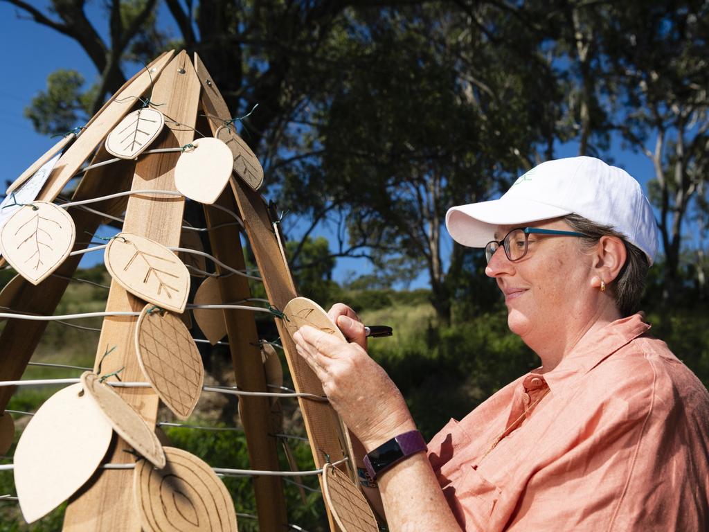 Hike to Heal committee member Fleur Winter with the tribute tree made by Toowoomba West Men's Shed members for people to write messages of rememberance, hope and healing at Mt Peel Bushland Park, Saturday, February 19, 2022. Picture: Kevin Farmer