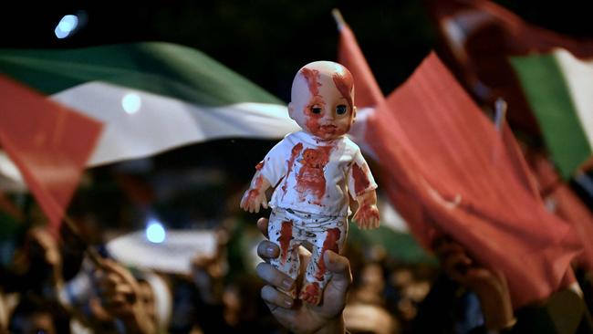 A demonstrator holds a doll with red paint during a rally in support of Palestinians, outside the US Consulate in Istanbul.