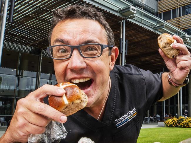 Doctor Morne Terblanche welcomes some of the 7500 Hot Cross Buns to be donated to health workers at Sunshine Coast University Hospital by Bakers Delight Birtinya over Easter. Photo Lachie Millard