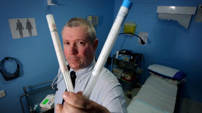 Dr Thomas Lyons, with oral and nasal viral swabs, will refer some patients for testing at a fast-track drive-through clinic outside his Eagleby surgery.