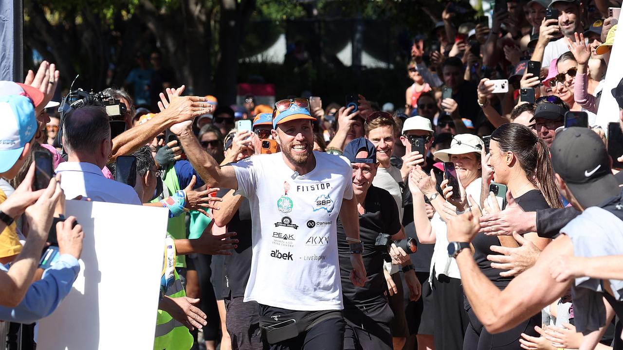 Tim Franklin acknowledges his supporters as he heads for the finish line. Picture: Liam Kidston