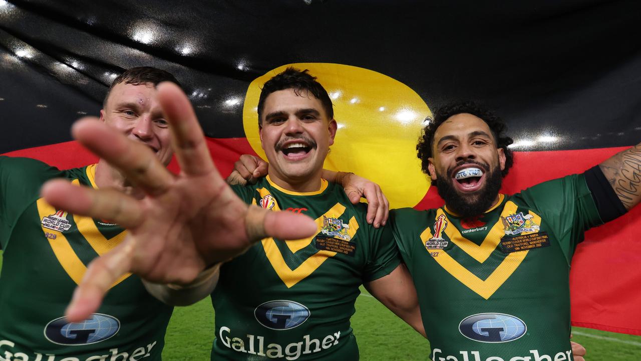 (L-R) Jack Wighton, Latrell Mitchell and Josh Addo-Carr of Australia celebrate with the Aboriginal flag following their side's victory in the Rugby League World Cup Final. Picture: George Wood/Getty Images