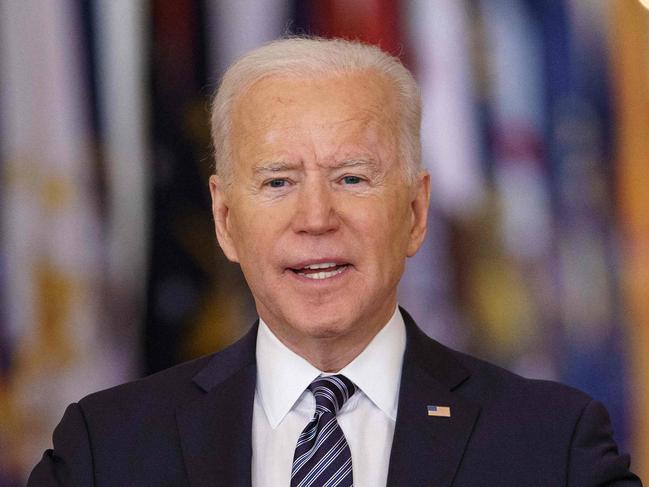 US President Joe Biden gestures as he speaks on the anniversary of the start of the Covid-19 pandemic, in the East Room of the White House in Washington, DC on March 11, 2021. (Photo by MANDEL NGAN / AFP)