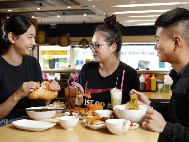 Tan Viet Noodle House has stood in Cabramatta for 27 years but people still keep coming back for more of the Lam family's famous crispy skin chicken. From left Jessie Lam enjoying lunch with Bernice Tran and Khang Tran. Picture: Jonathan Ng