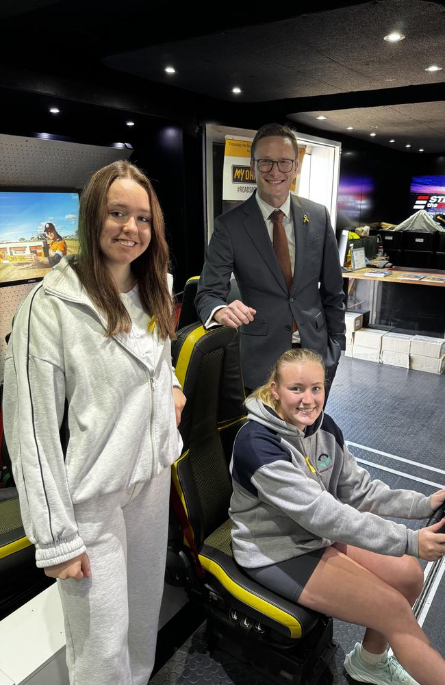 RACT's Mark Mugnaioni with Tara Lette (seated) and Ashtyn Thorn on the Steering the Future simulator for National Road Safety Week 2025. Picture: Supplied