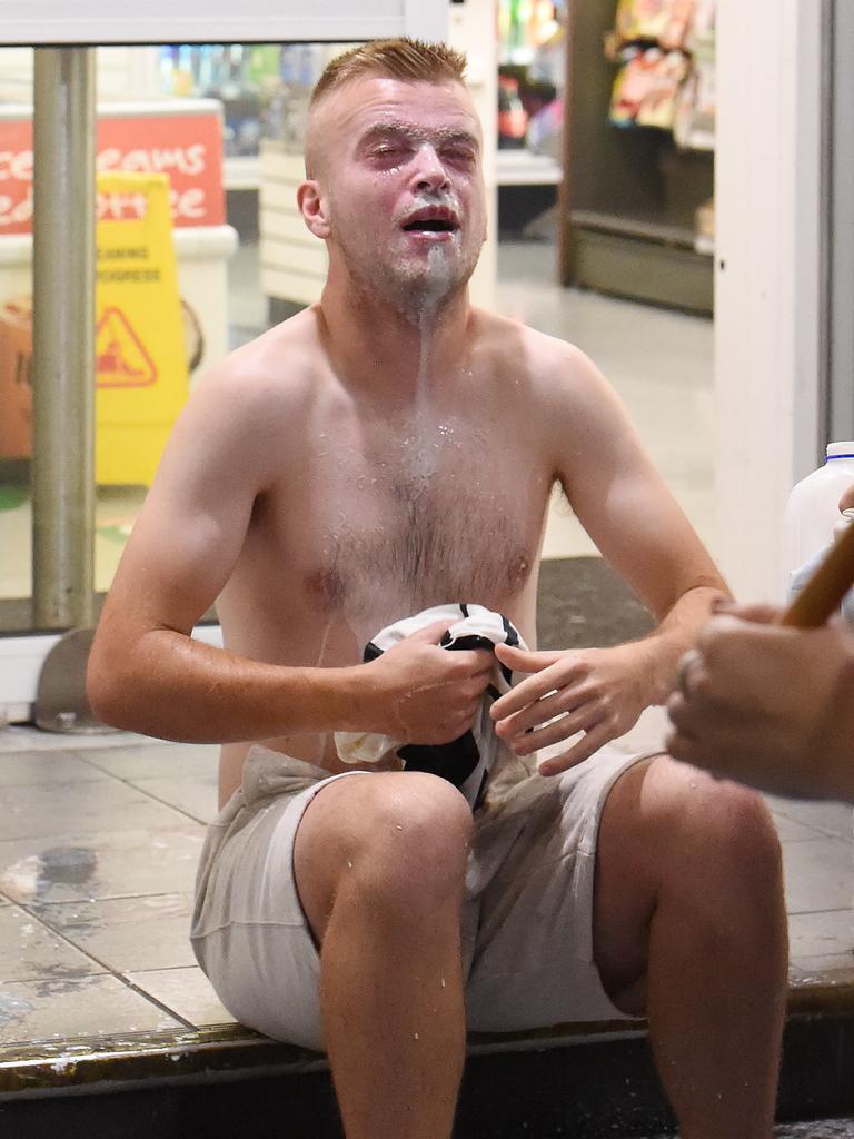 A man douses his face with milk after being pepper sprayed.