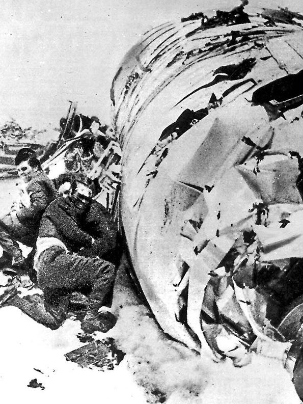 Made it through ... Survivors of the First XV Christian Brothers Rugby Team and wreckage of their plane which crashed in the Andes Mountains. Picture: Supplied