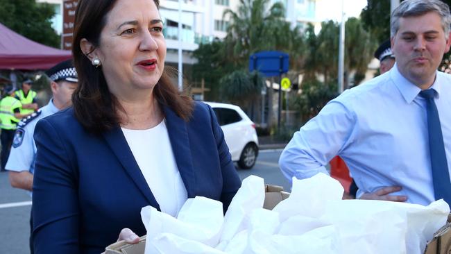 Premier Annastacia Palaszczuk and Police Minister Mark Ryan with food at the border this morning. Picture: Adam Head