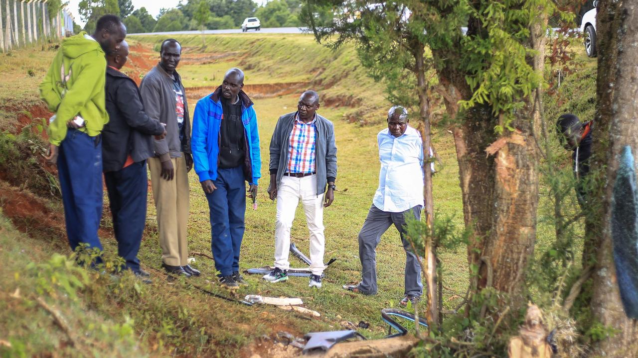 Members of the public gather at the scene of accident. (Photo by AFP)