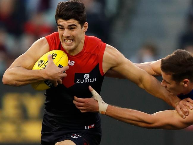 MELBOURNE, AUSTRALIA - JULY 14: Christian Petracca of the Demons fends off Josh Dunkley of the Bulldogs during the 2018 AFL round 17 match between the Melbourne Demons and the Western Bulldogs at the Melbourne Cricket Ground on July 14, 2018 in Melbourne, Australia. (Photo by Michael Willson/AFL Media/Getty Images)