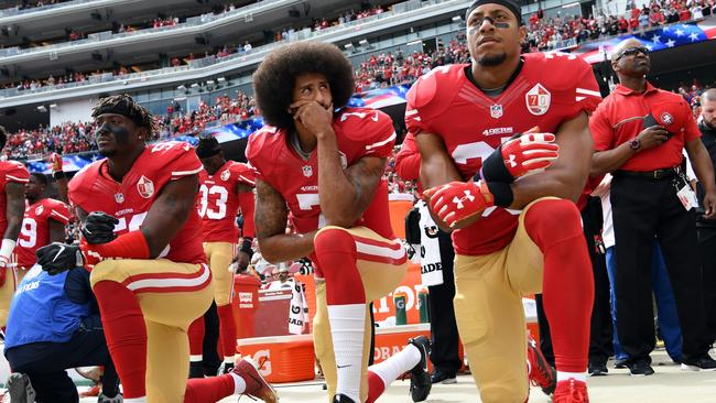 Colin Kaepernick, centre, takes a knee during the American anthem at Levi's Stadium in 2016 when he was with the San Francisco 49ers.