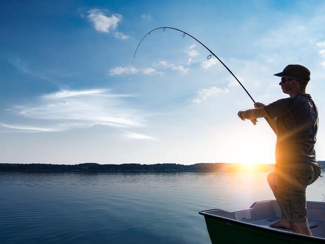 fishing rod lake fisherman men sport summer lure sunset water outdoor sunrise fish - stock image