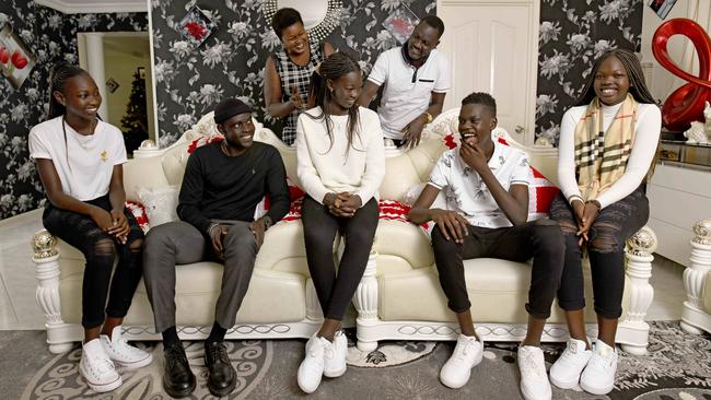 Awur Deng (centre), lives at home in Salisbury Plain with 10 siblings including, from left, Akur Ayuen Deng (12), Deng Leek Aleer (19), Anyuat Ayuen Deng (13) and Atong Ayuen Deng (15) and parents Adut Aleer Deng and Solomon Ayuen Deng. Picture: Naomi Jellicoe