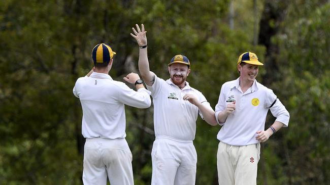 Lower Eltham’s Kane Richards, centre, celebrates catching Daniel Gilbert.