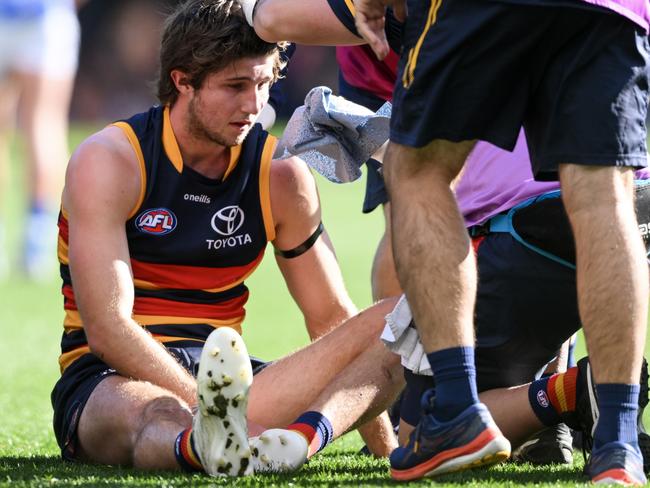 ADELAIDE, AUSTRALIA - JULY 01: Jordan Butts of the Crows is treated after a head clash with Callum Coleman-Jones of the Kangaroos during the round 16 AFL match between Adelaide Crows and Melbourne Demons at Adelaide Oval, on July 01, 2023, in Adelaide, Australia. (Photo by Mark Brake/Getty Images)