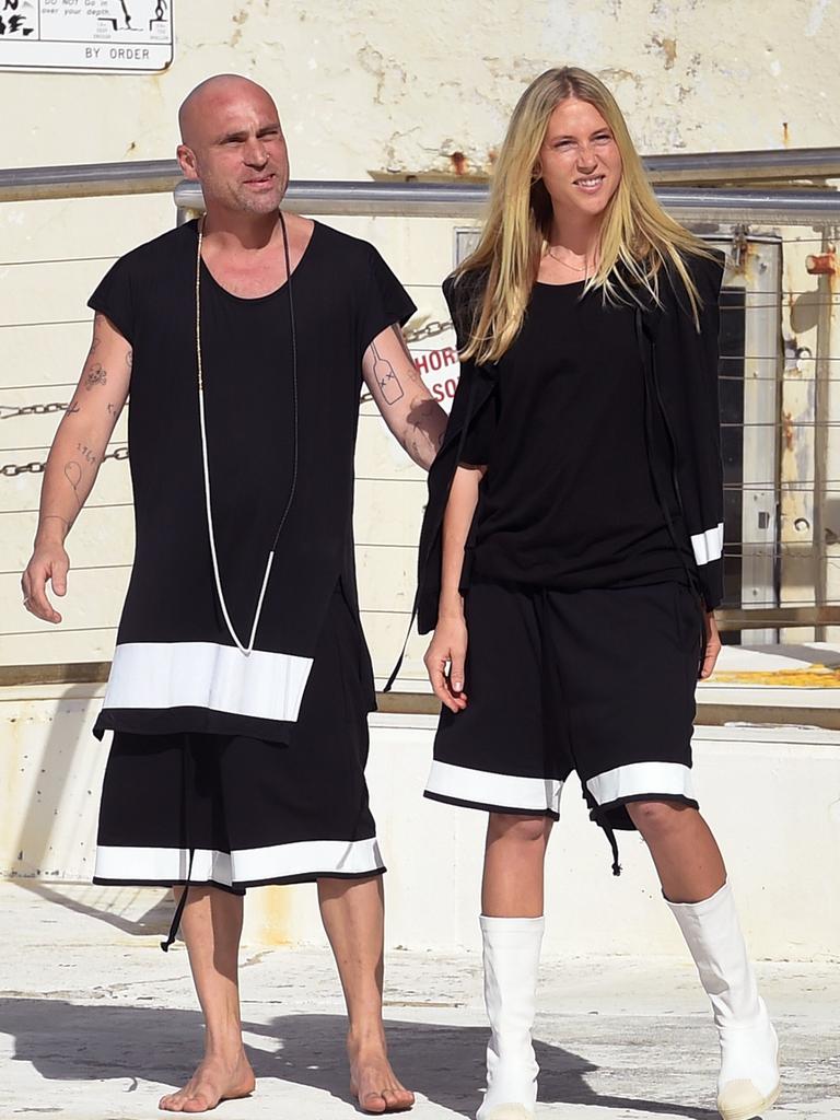 Australian designers Maurice Terzini and Lucy Hinckfuss acknowledge the applause after a showing of their fashion label Tenpieces at Bondi Beach during Fashion Week Australia. Picture: AFP