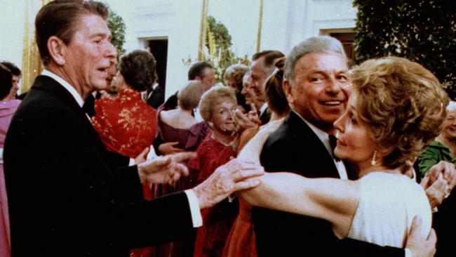 Ronald Reagan in 1981, cutting in on dance between his wife Nancy and singe/actor Frank Sinatra.