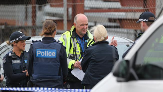 Police having a discussion near the crime scene at North Shore in Geelong. Picture: Mike Dugdale