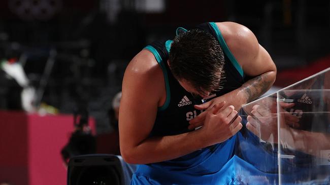 Luka Doncic reacts after injuring himself while chasing a loose ball out of bounds and running into the scorers table. (Photo by Kevin C. Cox/Getty Images)