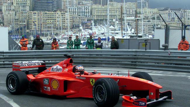 With Monte Carlo’s stunning vista in the background, Michael Schumacher purrs around the street circuit in his Ferrari ahead of his win in the 1999 Monaco Grand Prix.