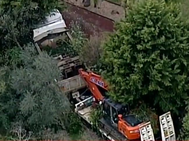 A woman has been killed by a truck carrying an excavator in Donvale. Nine News