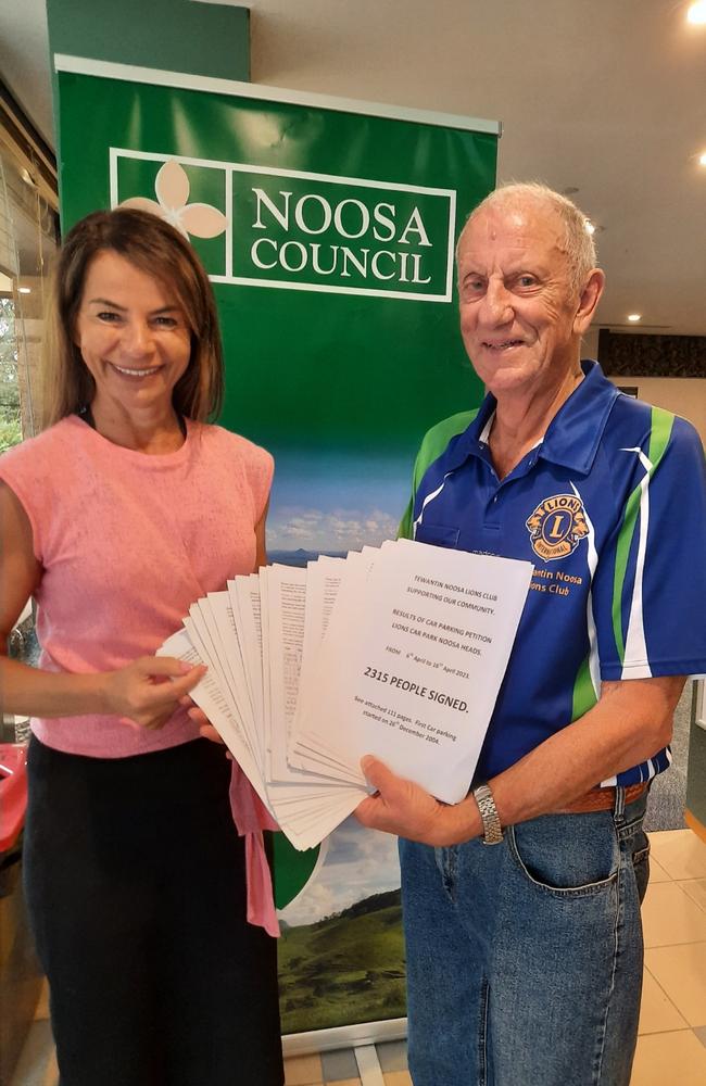 Tewantin Noosa Lions Club member Michael Roach hands Noosa councillor Amelia Lorentson a petition regarding school holiday carparking at the Noosa Heads Lions Park. Picture: Contributed