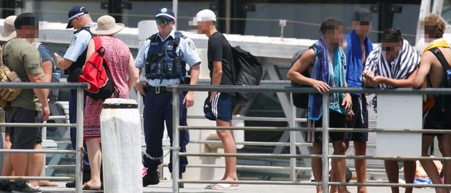 Police talk to young people, and take down their names, after complaints on Thursday about people leaping from Manly Wharf. Picture: Tim Pascoe