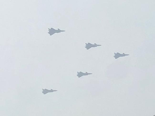 Chinese J-20 stealth fighter aircraft fly in formation above residential buildings in Beijing on June 13, 2021, during a rehearsal of an event marking the 100th anniversary of the founding of the Communist Party, scheduled for July 1. (Photo by SEBASTIEN RICCI / AFP)