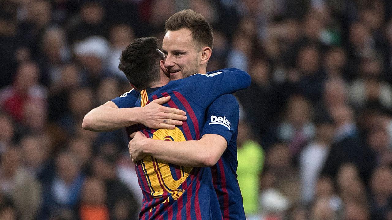 Barcelona midfielder Ivan Rakitic celebrates with Leo Messi.