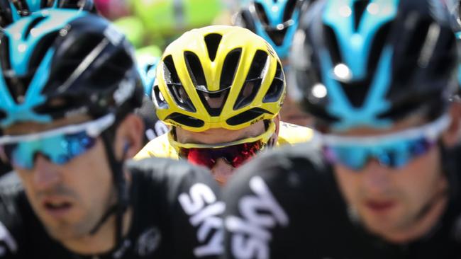 Great Britain's Christopher Froome (C), wearing the overall leader's yellow jersey, rides among his teammates during the 162,5 km eleventh stage of the 103rd edition of the Tour de France cycling race on July 13, 2016 between Carcassonne and Montpellier. / AFP PHOTO / KENZO TRIBOUILLARD