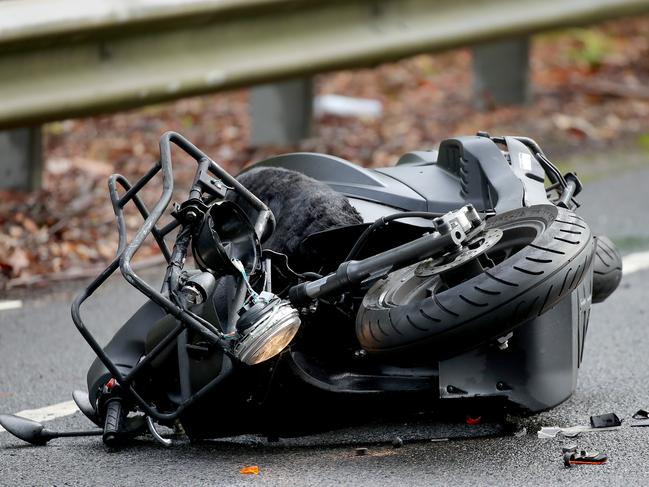 The wreckage of a motorcycle that collided with a small hatchback on Wakehurst Parkway at Narrabeen, which left a female rider, in her 30s, with serious leg injuries. Picture: Toby Zerna