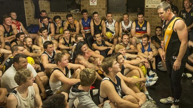 Shane Crawford, right, chats with Aldinga Sharks players.