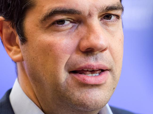 Greek Prime Minister Alexis Tsipras speaks with the media after a meeting of eurozone heads of state at the EU Council building in Brussels on Monday, July 13, 2015. A summit of eurozone leaders reached a tentative agreement with Greece on Monday for a bailout program that includes "serious reforms" and aid, removing an immediate threat that Greece could collapse financially and leave the euro. (AP Photo/Geert Vanden Wijngaert)