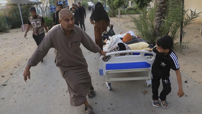 Palestinians evacuate patients from the European Hospital in Khan Younis, Gaza, after it was hit by an Israeli army airstrike. Picture: AP Photo