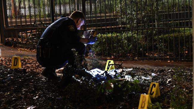 Police forensic investigator examines the crime scene. Picture: Gordon McComiskie