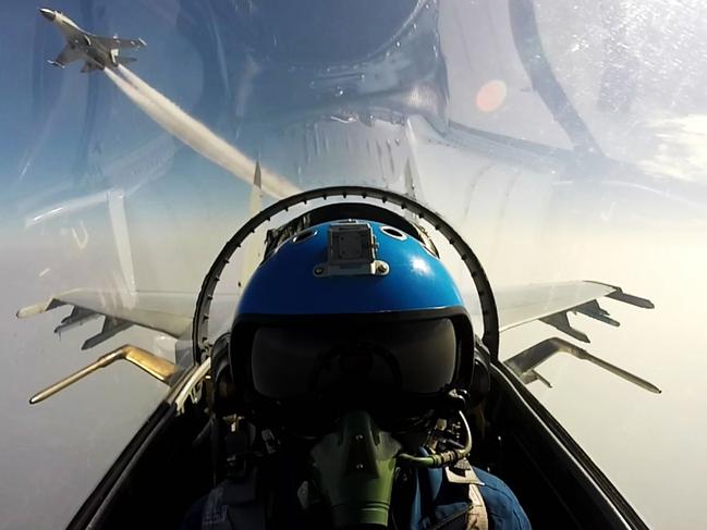 TOPSHOT - This undated photo shows two Chinese jet fighters during a military drill in the South China Sea near China's Hainan Island. An area off the east coast of China's island province of Hainan hosted military exercises from July 19 to 21. / AFP PHOTO / STR / China OUT