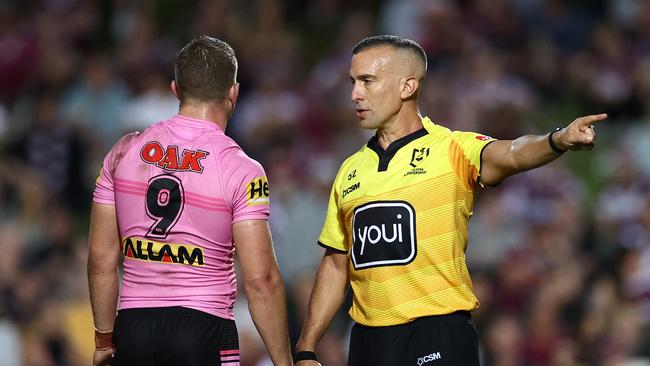 Referee Matt Cecchin places Mitch Kenny of the Panthers on report for a crusher tackle.