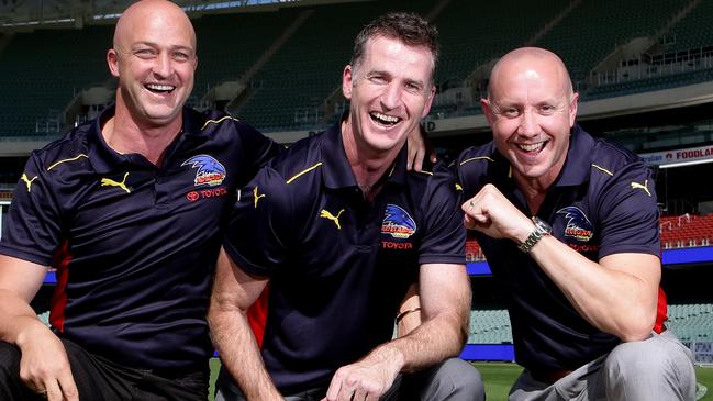 Crows premiership teammates Kym Koster, Peter Caven and Rod Jameson in happier days with at Adelaide Oval with the clubs two Grand Final cups. PIC SARAH REED