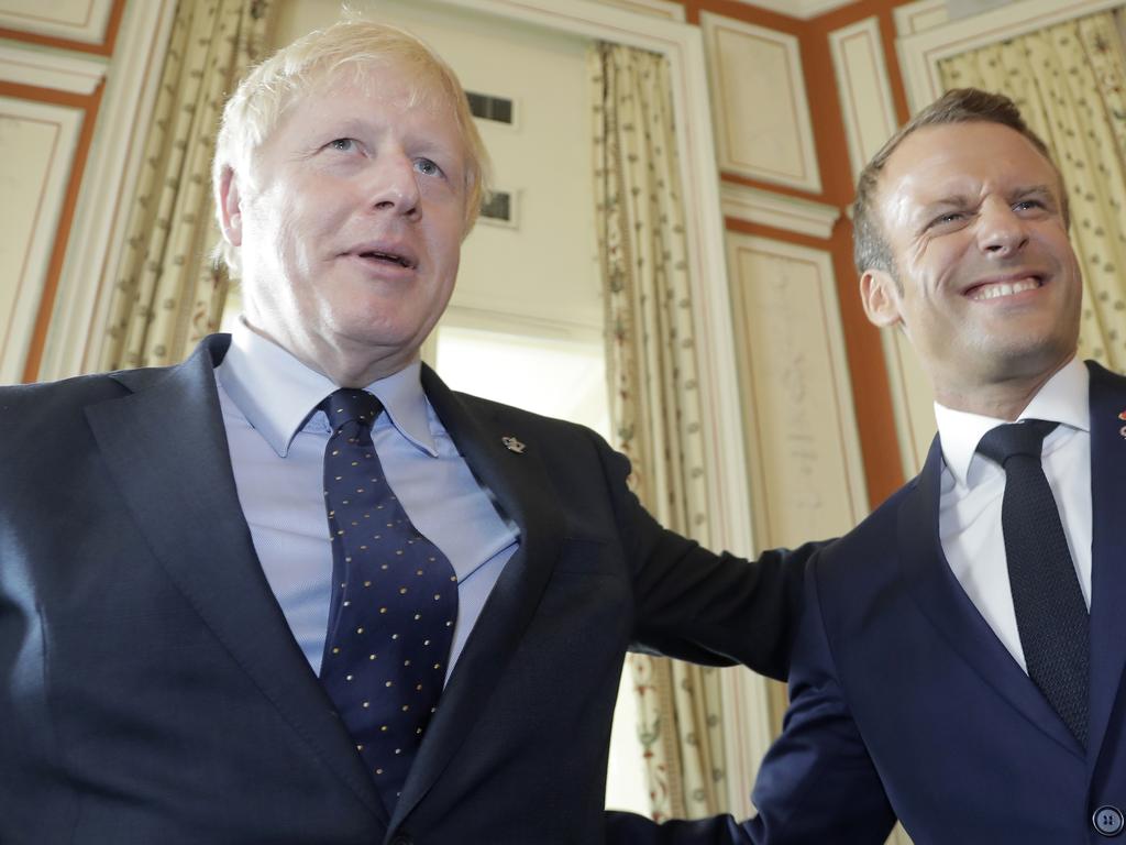 Britain's Prime Minister Boris Johnson, left, and French President Emmanuel Macron smile during a G7 coordination meeting. Picture: AP Photo/Markus Schreiber, Pool