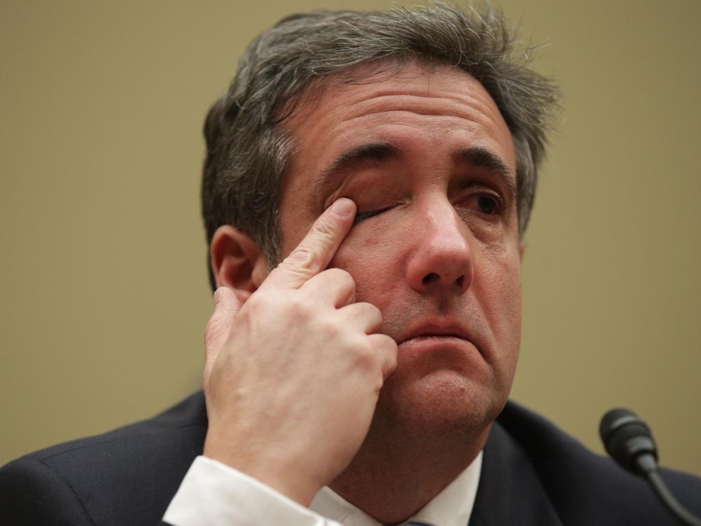 Michael Cohen in an emotional moment, listening to Rep. Elijah Cummings give his closing statement on Capitol Hill. Picture: AFP 