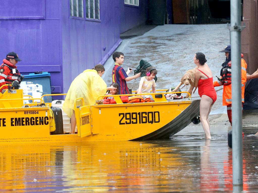 A family being rescued at Baroona Rd on Sunday. Picture: Steve Pohlner