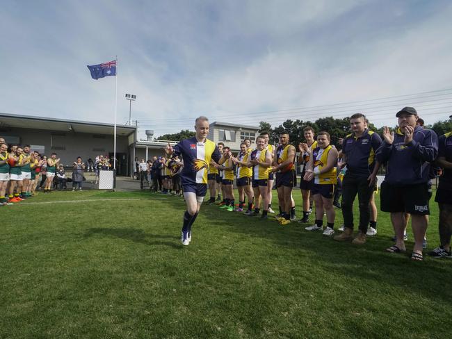 Players from both teams lined up to clap Tony Mertis on to the ground. Picture: Valeriu Campan