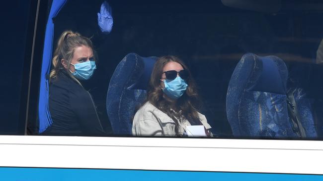 Relieved crew members from the disease-stricken Ruby Princess cruise ship are taken to a hotel in Sydney before flying out to their home countries. Picture: Simon Bullard