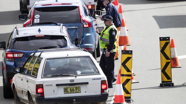 Police and army at the Queensland border. Picture: NIGEL HALLETT