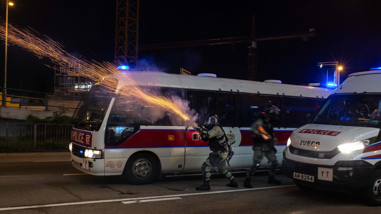 Riot police deploy tear gas towards protesters during a demonstration in Hong Kong last night. Picture: Getty Images