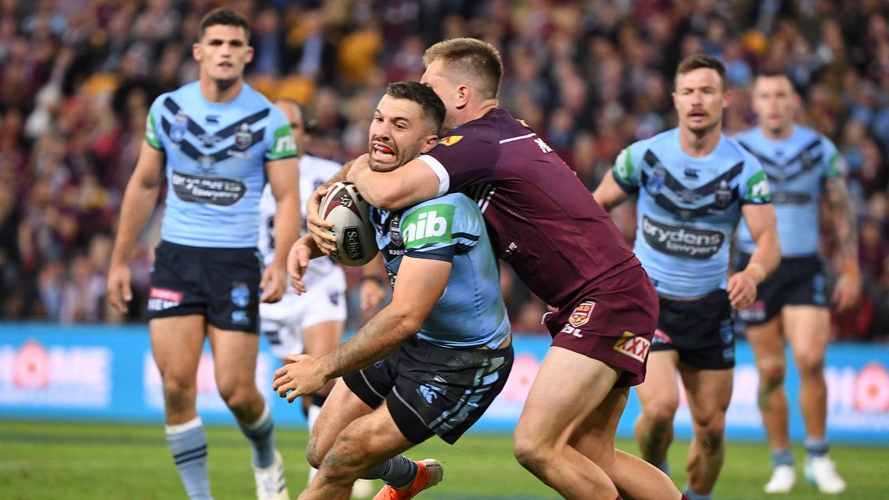 Cameron Munster of the Maroons tackles James Tedesco during game one