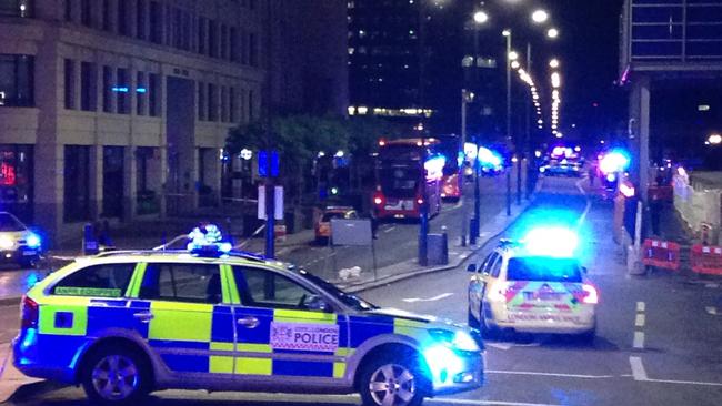 A photograph taken on a mobile phone shows British police cars blocking the entrance to London Bridge following an incident on the bridge. Picture: AFP PHOTO / Daniel SORABJI